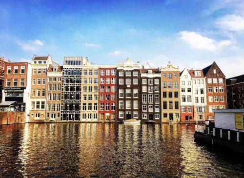 a group of buildings next to a body of water at Facade Hotel Amsterdam in Amsterdam