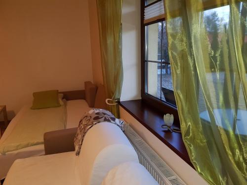 a bedroom with two beds and a window at Villa Sole in Pruszcz Gdański
