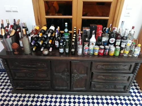 a cabinet filled with lots of bottles of alcohol at Riad Amor - Suite & Spa in Fès