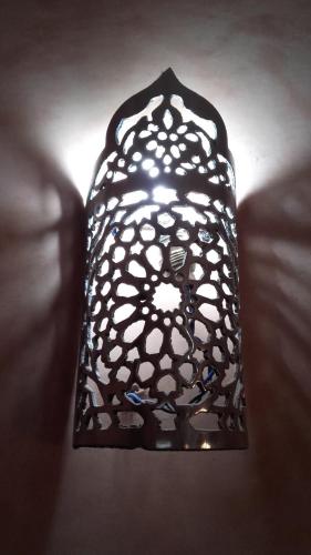 a black and white lamp sitting on a couch at Hotel AMOUDOU فندق أمودو in Tiznit