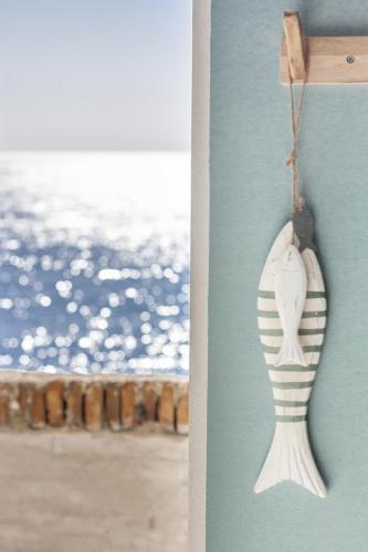 a seashell hanging on a wall next to a beach at Miramare love nest 5terreparco in Riomaggiore
