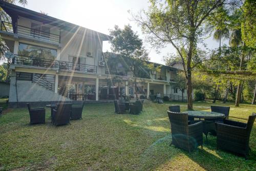 a group of chairs and tables in front of a building at Athena Lake by Seedevi in Dambulla