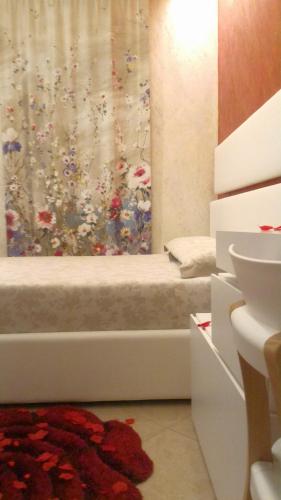 a bathroom with a bath tub with a shower curtain at Luxury B&B Coccolhouse in San Cesario di Lecce