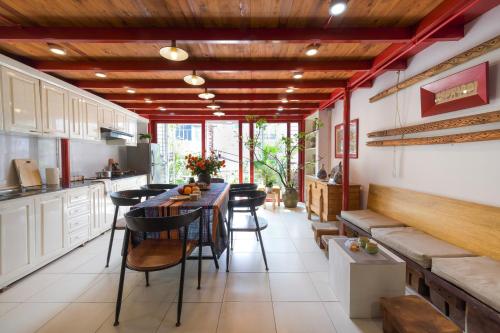 a kitchen with a table and chairs in a room at Hanoi Secret Garden in Hanoi