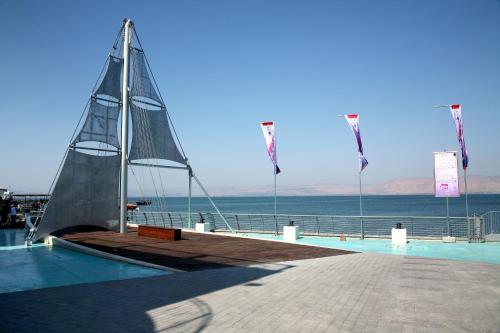 kites are being flown in the water at Shirat Hayam Boutique Hotel in Tiberias