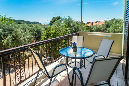 a balcony with a table and chairs and a view at Studios Evis in Potos