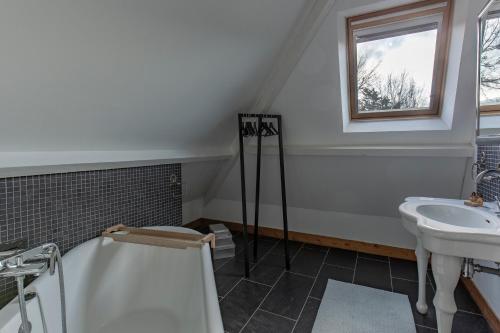a bathroom with a shower and a sink and a tub at Domaine du Grand Bec in Villerville