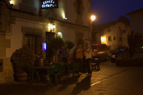 a group of people standing on a street at night at Hostal Rural Elosta in Lekunberri