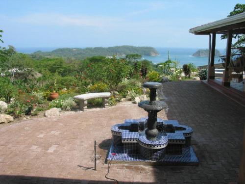 a stone fountain sitting on top of a patio at Beautifull Casa Pastor in Sámara