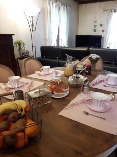 a dining room table with plates of food on it at Chez Pascaline in Sarliac-sur-lʼIsle