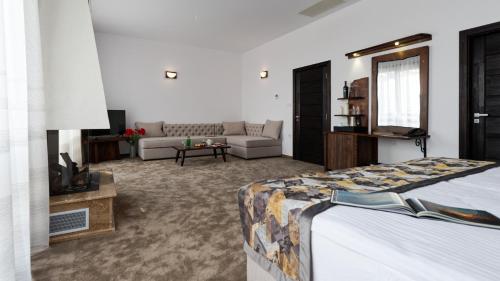 a bedroom with a bed and a living room at Wine & Spa Complex Starosel in Starosel