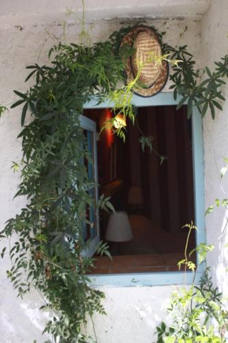 a window with a wreath on the side of a building at Posada del Castaño in Castaño de Robledo