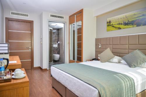 Una cama o camas en una habitación de Hakcan Hotel