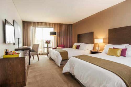Postel nebo postele na pokoji v ubytování Hotel Morrison Usaquén
