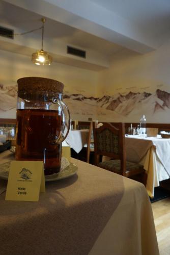 a jar of honey sitting on top of a table at Hotel Biancaneve in Cogolo