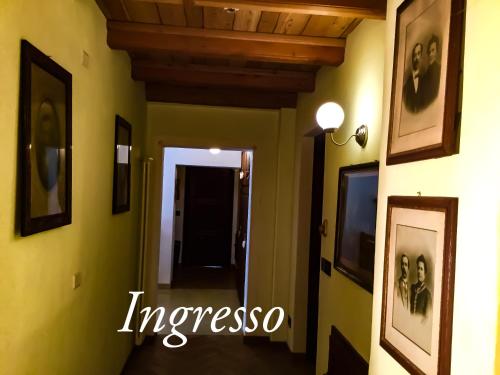 a hallway with paintings on the walls of a house at Agriturismo B&B Chèvres à Cheval in Aosta
