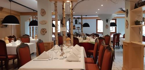 a dining room with tables and chairs with glasses on them at Hostellerie Les Bagenelles in Sainte-Marie-aux-Mines