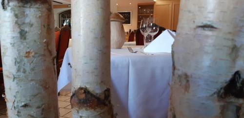 a table in a restaurant with a white table cloth at Hostellerie Les Bagenelles in Sainte-Marie-aux-Mines