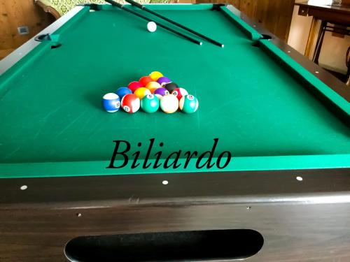 a green pool table with balls on it at Agriturismo B&B Chèvres à Cheval in Aosta