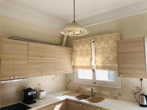 a small kitchen with a sink and a window at Sea voyage in Nafplio