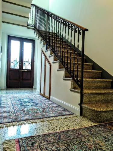 a staircase in a house with a rug at Residenza Laurum in Mandello del Lario