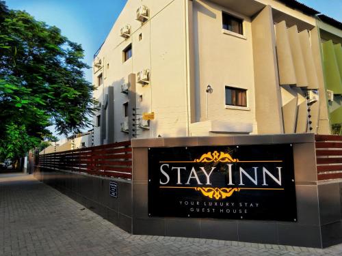 a sign that says stay inn in front of a building at Stay Inn - Guest House in Maputo
