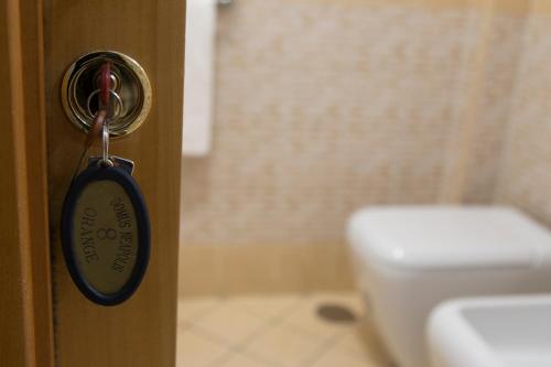 a bathroom with a door knob and a toilet at Campi Flegrei House in Naples