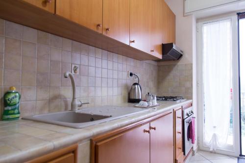 a kitchen with a sink and a counter top at Campi Flegrei House in Naples