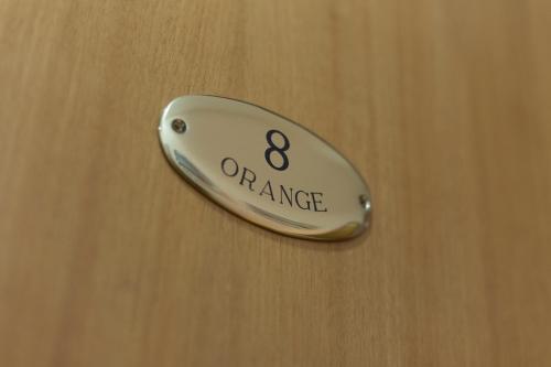 a door knob with the orange sign on it at Campi Flegrei House in Naples