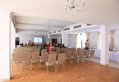 a room with a group of people sitting in a room at Hotel Camelot in Szczawno-Zdrój