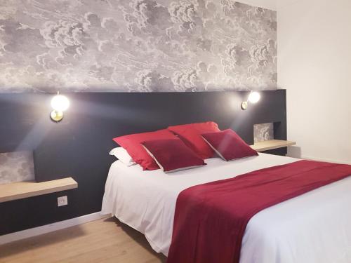 a bedroom with a large bed with red pillows at L'Impératrice - en cœur de Bastide de Geaune in Geaune