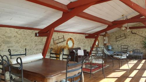 a room with a table and chairs in a building at L'Impératrice - en cœur de Bastide de Geaune in Geaune