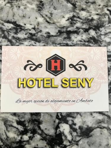 a hotel sent sign on a granite counter top at Hotel Seny in Ambato