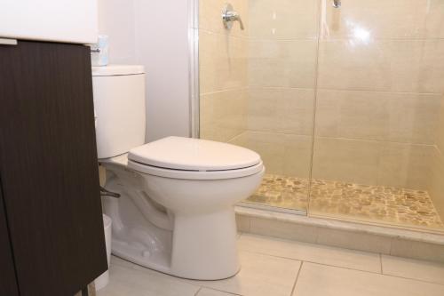 a bathroom with a toilet and a shower at A Stylish Stay w/ a Queen Bed, Heated Floors.. #24 in Brookline