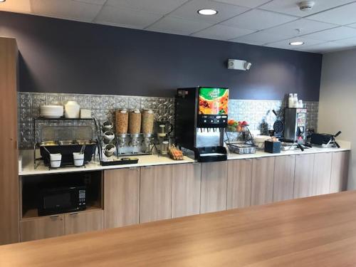 a kitchen with a counter in a restaurant at Microtel Inn & Suites by Wyndham Georgetown Delaware Beaches in Georgetown