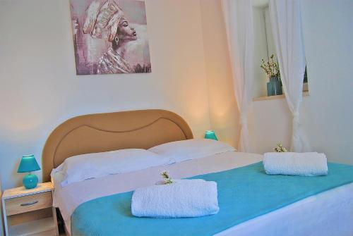 a bedroom with two beds with towels on them at Apartments Vidilica in Split
