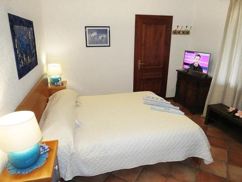 a bedroom with a bed and a tv in it at Apartments Ruby in Funtana