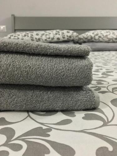 a pile of towels sitting on the floor in a bedroom at B&B Sole in Ravenna