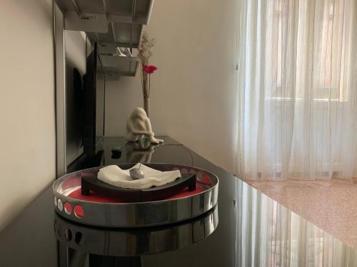 a room with a statue of a person sitting in a room at Temporary House Oberdan in Bologna