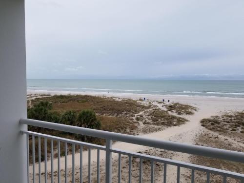 a view of the beach from the balcony of a condo at Provident Oceana Beachfront Suites in St Pete Beach