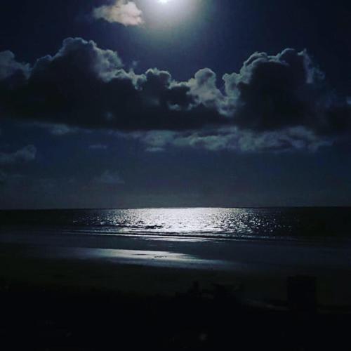 a full moon over the ocean at the beach at Parador Algaroba in Japaratinga
