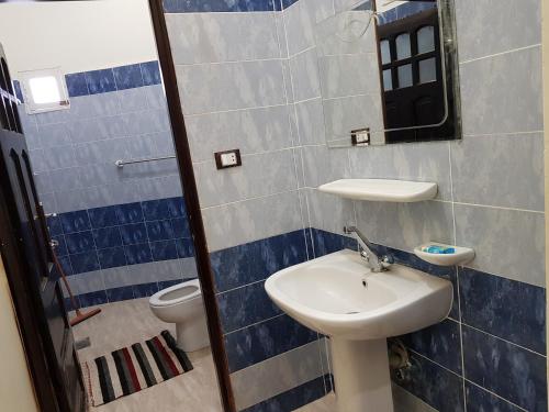 a bathroom with a sink and a toilet at Qasr El salam in Siwa