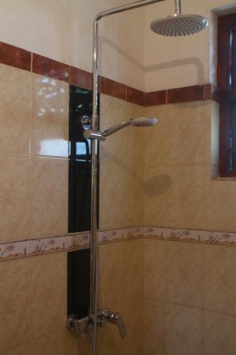 a shower with a glass door in a bathroom at Villa184 in Ahungalla