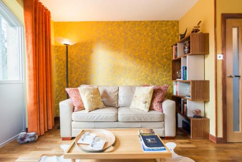 a living room with a couch and a table at The Queens View in Edinburgh