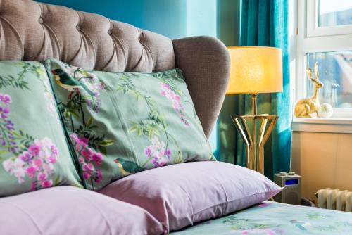 a bed with two pillows and a lamp in a room at The Queens View in Edinburgh