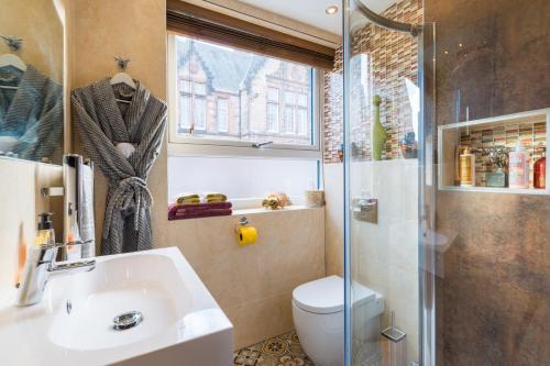 a bathroom with a shower and a sink and a toilet at The Queens View in Edinburgh