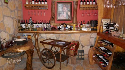a bar with a bike and wine bottles at Pousada Cachoeiras de Milho Verde in Milho Verde