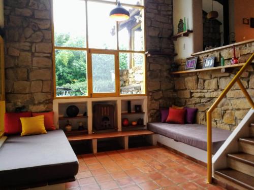 a living room with a bench and a fireplace at La Vista - Un lugar de Ensueño in Samaipata