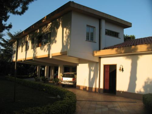 a white building with a car parked in front of it at B&B Villa Maria in Montesilvano