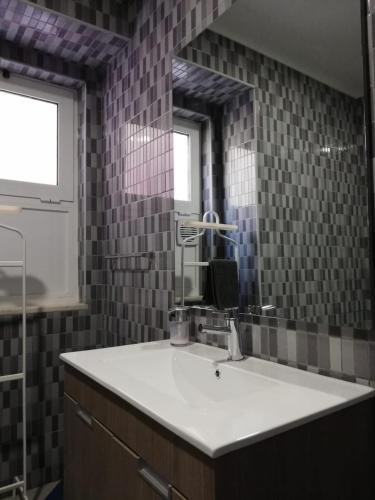 a bathroom with a sink and a mirror at BED&SHOWER Moscavide -Self Check-In in Lisbon